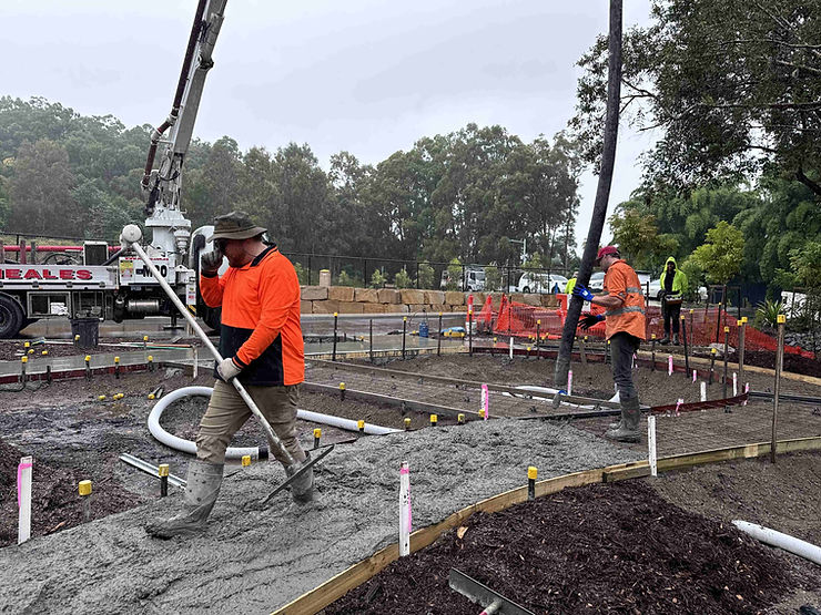 Civil concreting team coordinating concrete pump and truck deliveries on active Gold Coast site
